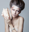 Beautiful woman with seashell posing isolated. Series of photos