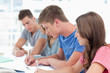 Side view of four students working together