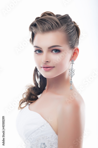 Photo: Slim beautiful woman fiancee in luxurious wedding dress Slim beautiful woman fiancee in luxurious wedding dress