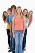 Full length shot of a smiling group standing behind one another
