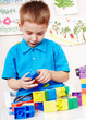 Child playing construction set.