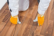 Photo: worker analyzing wooden floor for cracks worker analyzing wooden floor for cracks