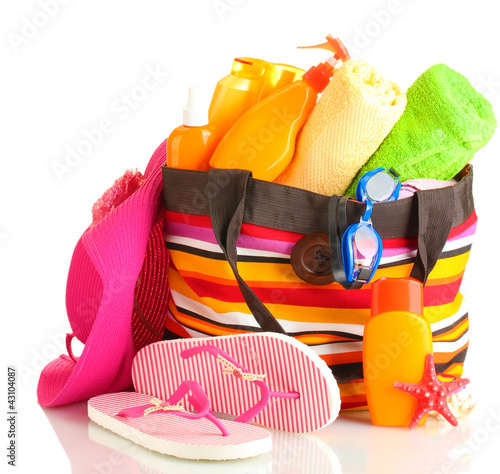 Photo: Beach bag with beach accessories, isolated on white Beach bag with beach accessories, isolated on white