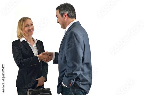 Photo: Smiling businessman and businesswoman shaking hands. Smiling businessman and businesswoman shaking hands.