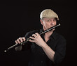 Portrait of a man playing ols wooden transverse flute