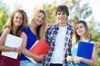 Portrait happy young students in park