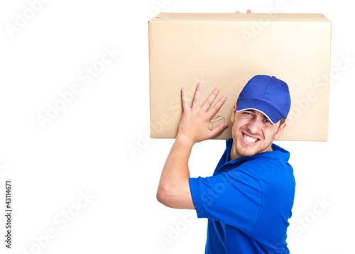 Photo: Dlivery boy holding heavy package Dlivery boy holding heavy package