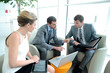 Photo: Business people meeting in trade fair building hall Business people meeting in trade fair building hall
