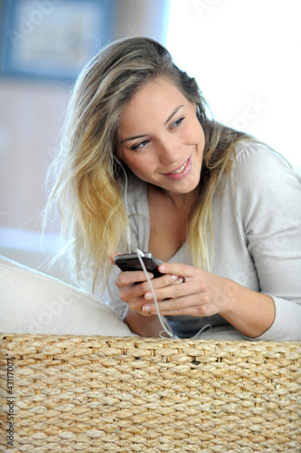 Photo: Beautiful young woman using handsfree device on mobile phone Beautiful young woman using handsfree device on mobile phone
