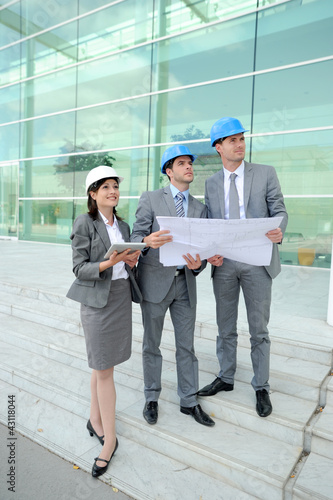 Photo: Business people checking construction site Business people checking construction site