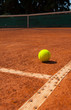 Photo: Tennis ball on clay court Tennis ball on clay court