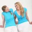 Two friendly female colleagues sitting close together