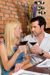 Attractive couple drinking red wine in restaurant or bar