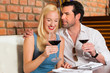 Attractive couple drinking red wine in restaurant or bar
