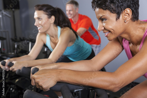 Photo: African American Woman Spinning Exercise Bike at Gym African American Woman Spinning Exercise Bike at Gym