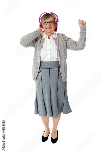 Photo: Old woman enjoying music Old woman enjoying music