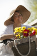 Woman with bicycle and flowers