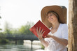 Woman reading by the river