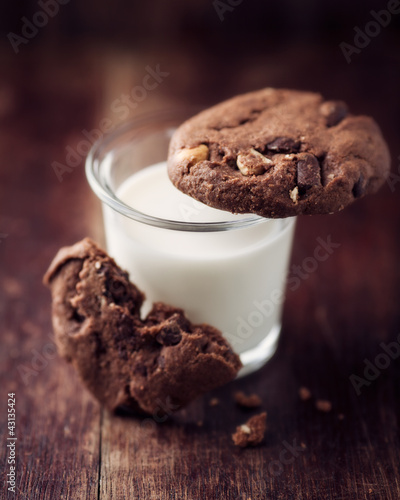 Photo: Glass of milk and chocolate cookies with nuts Glass of milk and chocolate cookies with nuts