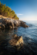 Foto: Rocky Croatian beach at sunset. Rocky Croatian beach at sunset.