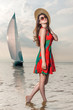 girl in a dress with poppy enjoys the weather