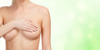 Woman controlling her breast for cancer