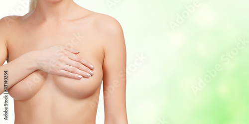 Photo: Woman controlling her breast for cancer Woman controlling her breast for cancer