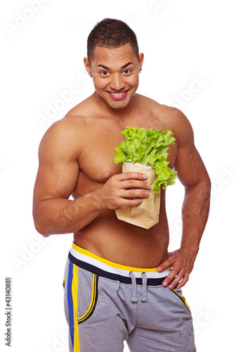 Photo: Portrait of handsome man posing on white background with salad Portrait of handsome man posing on white background with salad