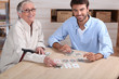 Young playing cards with senior woman