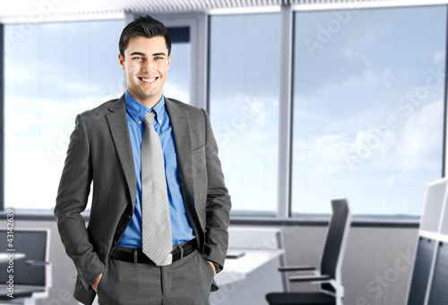 Foto: Smiling businessman in his office Smiling businessman in his office