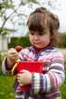 Girl of three years old with berries