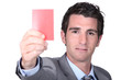 portrait of a man holding red card