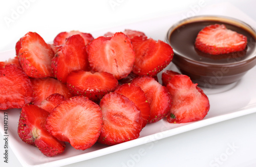 Photo: Fresh strawberries on plate with chocolate close-up Fresh strawberries on plate with chocolate close-up