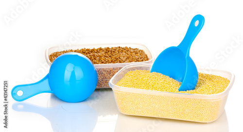 Photo: Measuring spoons and plastic containers with grain isolated Measuring spoons and plastic containers with grain isolated