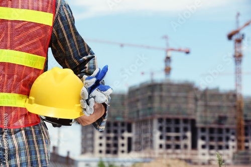 Photo: man holding yellow helmet man holding yellow helmet