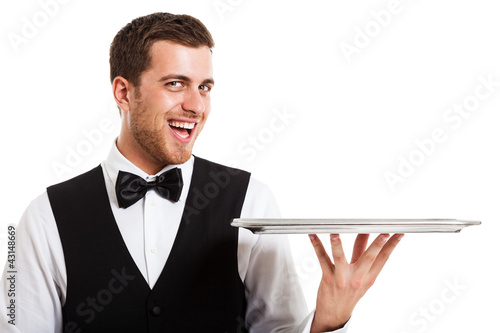 Photo: Smiling waiter holding an empty dish Smiling waiter holding an empty dish