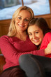 Photo: Portrait Of Mother And Daughter Relaxing On Sofa Together Portrait Of Mother And Daughter Relaxing On Sofa Together