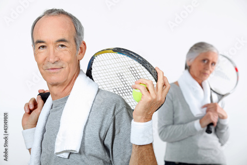 Photo: Older couple with tennis rackets Older couple with tennis rackets