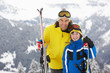Father And Son On Ski Holiday In Mountains