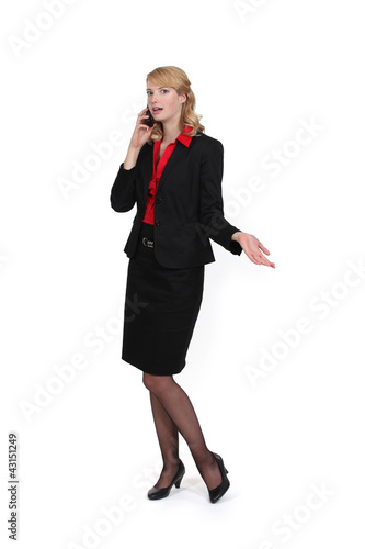 Photo: businesswoman talking on her cell businesswoman talking on her cell