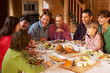 Photo: Two Familes Enjoying Meal In Alpine Chalet Together Two Familes Enjoying Meal In Alpine Chalet Together