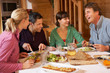 Photo: Group Of Friends Enjoying Meal In Alpine Chalet Together Group Of Friends Enjoying Meal In Alpine Chalet Together