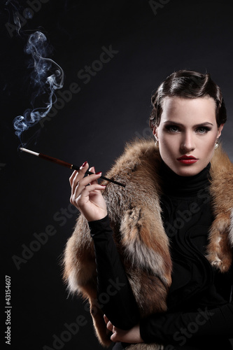 Photo: Woman with cigarette in vintage image Woman with cigarette in vintage image