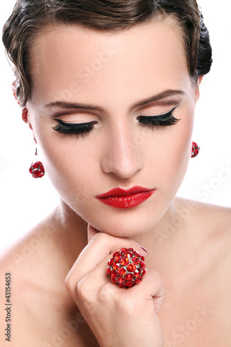 Photo: Young and beautiful woman with red jewelry Young and beautiful woman with red jewelry