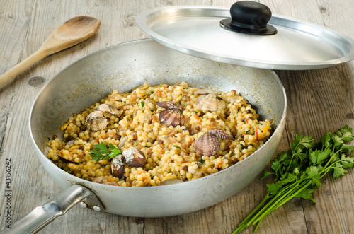 Photo: Fregola con arselle, recipe of typical pasta of Sardinia Fregola con arselle, recipe of typical pasta of Sardinia