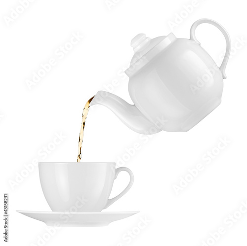 Photo: Teapot pouring tea into a cup on a white background Teapot pouring tea into a cup on a white background