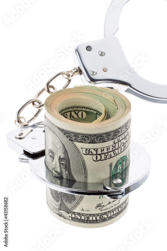 Photo: Dollar Geldscheine mit Handschellen Dollar Geldscheine mit Handschellen