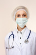 Portrait of serious young woman doctor in scrubs