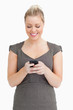 Photo: Woman texting on her smartphone Woman texting on her smartphone
