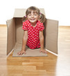 happy little girl inside a paper box